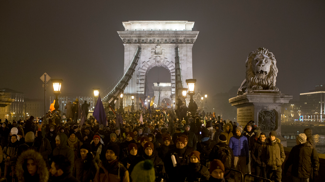 Thousands of protesters walk down Budapest’s famed Chain Bridge during an anti-government march in central Budapest, Hungary, Friday, Dec. 21, 2018.