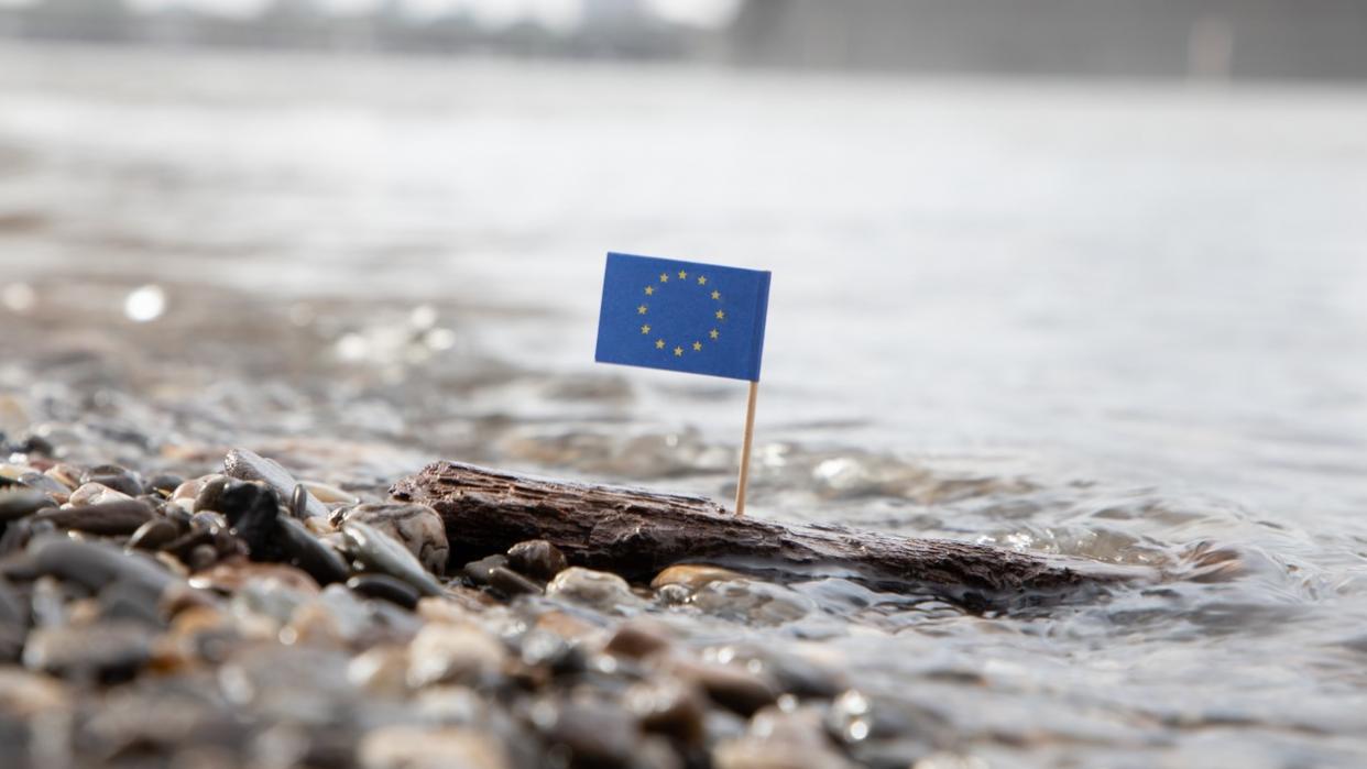 Photo of an EU flag surrounded by water