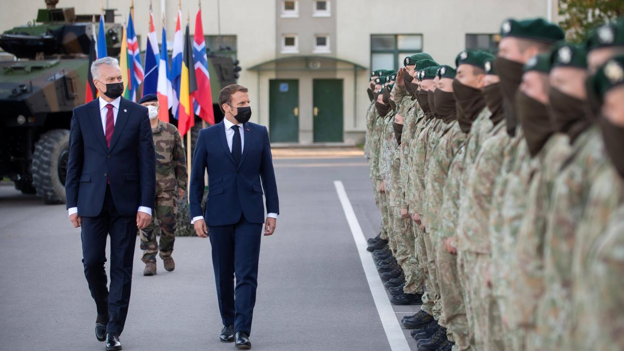 Image: Lithuanian President Gitanas Nauseda (1st L, Front) and French President Emmanuel Macron (2nd L, Front) inspect the NATO multinational battalion in Rukla, Lithuania, on Sept. 29, 2020.