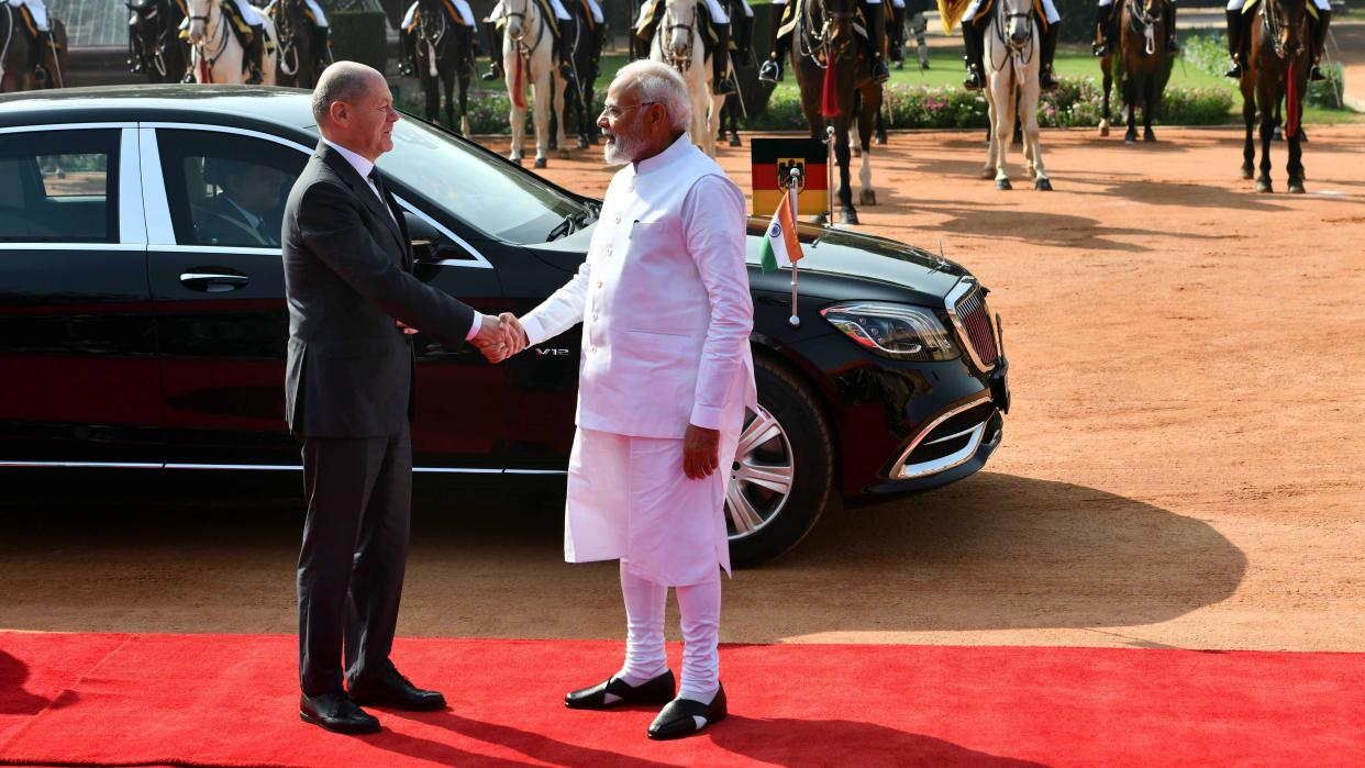 Indian Prime Minister Narendra Modi (R, front) greets German Chancellor Olaf Scholz during a ceremonial reception at Indian Presidential Palace in New Delhi, Feb. 25, 2023