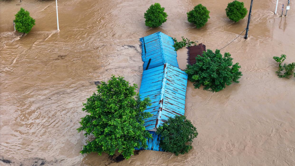 Houses and fields being flooded in Qiandongnan Prefecture, China, on June 29, 2024