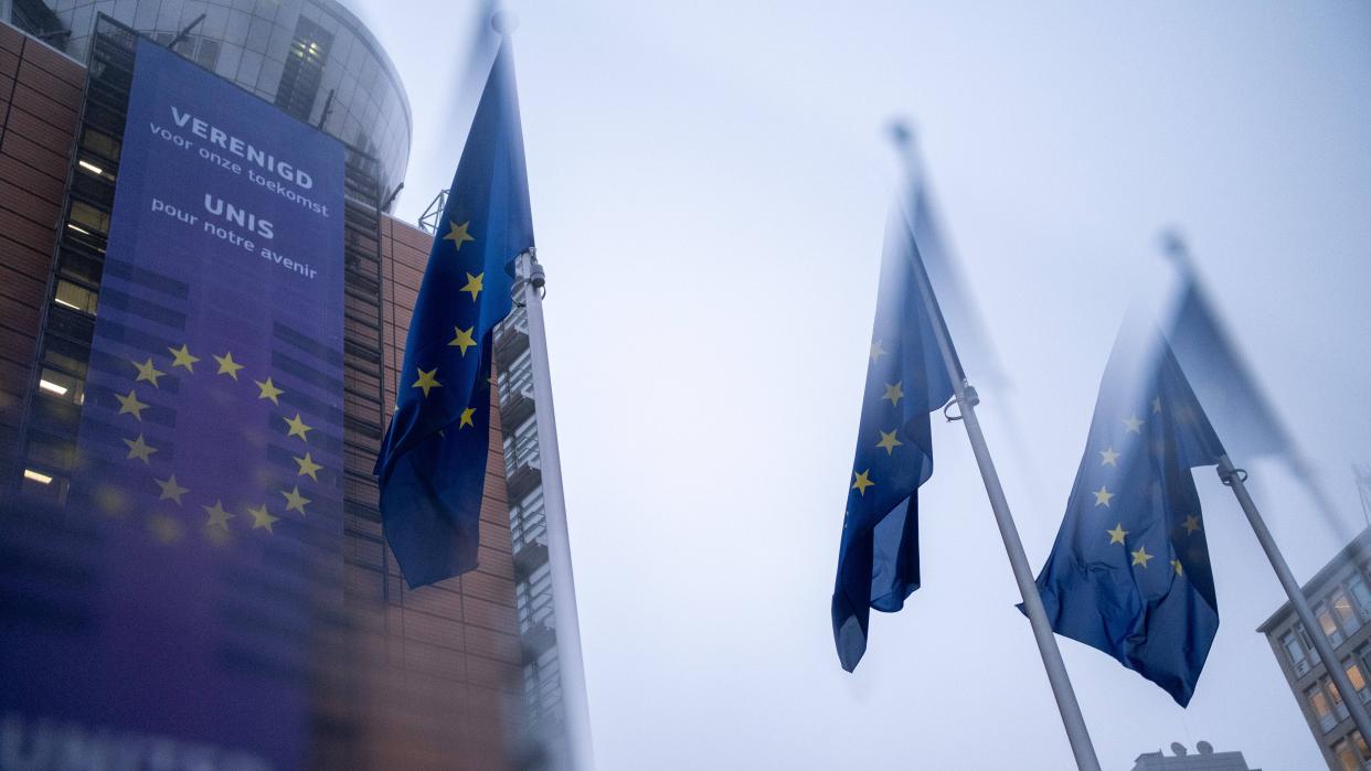 The Berlaymont headquarters of the European Commission shown blurred with gray skies in the background