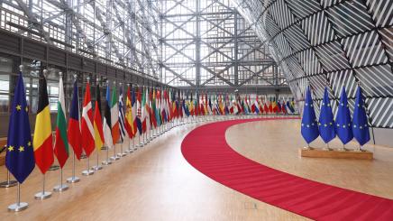 Forum of the Europa building in Brussels with EU and world flags