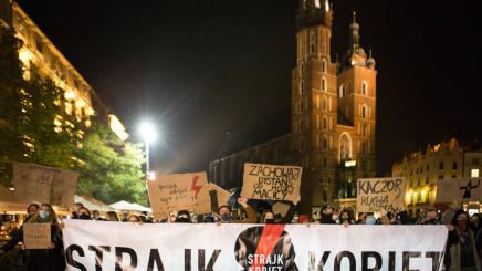 Female protestors in Poland with a 'Women on Strike' banner