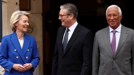 Britain's Prime Minister Keir Starmer and European Commission President Ursula von der Leyen react as they pose with European Council President Antonio Costa, ahead of the UK-EU Summit at Lancaster House in London on May 19, 2025.