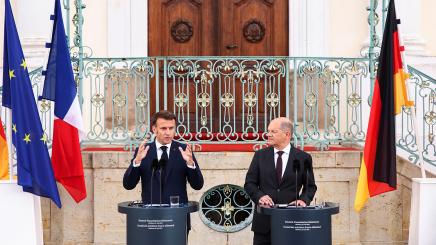 German Chancellor Olaf Scholz listens as French President Emmanuel Macron speaks to reporters on the day of a joint Franco-German cabinet meeting at the German government's guest house, Schloss Meseberg castle north of Berlin, in Gransee, Germany, May 28, 2024.