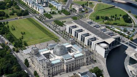 Blick auf das Regierungsviertel mit Reichstag {u), Paul-Löbe-Haus {r} und Kanzleramt. Das 75 Meter lange Luftschiff im Dienst der Helmholtz-Gemeinschaft startet seine Expedition «Uhrwerk Ozean» am Donnerstag in Berlin.