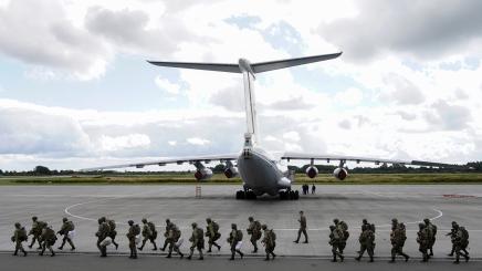 Russian paratroopers walk before boarding Ilyushin Il-76 transport planes as they take part in the military exercises "Zapad-2021" staged by the armed forces of Russia and Belarus at an aerodrome in Kaliningrad Region, Russia, September 13, 2021.