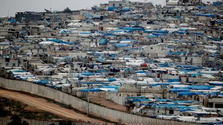 Tents housing internally displaced people in Atma camp in Idlib Governorate of Syria are seen on the Syrian side of the border zone near the Turkish village of Bukulmez in Hatay province