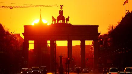 The sun rises behind Brandenburg Gate in Berlin, Germany, April 1, 2020.