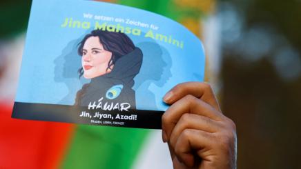 A demonstrator holds a poster during a protest following the death of Mahsa Amini in Iran, in Berlin, Germany, October, 22, 2022.