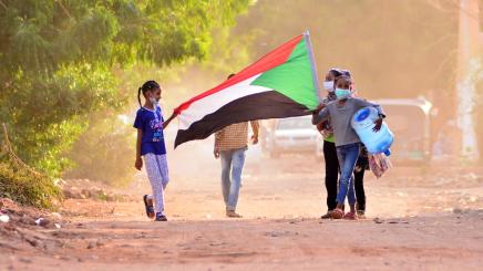 Children with a Sudanese flag in the capital Khartoum, on June 30, 2020. Tens of thousands of Sudanese took to the streets in several cities and the capital calling for reforms and demanding justice for those killed in anti-government demonstrations that ousted president Omar al-Bashir.