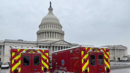 Photo of emergency vehicles standing by at the Capitol Building