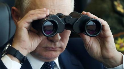 Russia's President Vladimir Putin looks through binoculars during the joint Russian-Belarusian military exercise Zapad 2021
