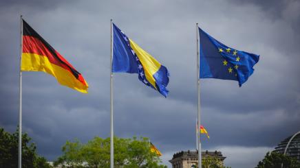 The flags of Germany, Bosnia and Herzegovina and the European Union fly in front of the Reichstag building